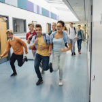 Photo of students running in hall