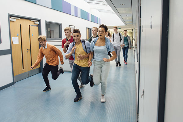 Photo of students running in hallway