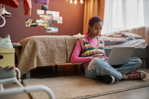 Teenage girl using laptop
