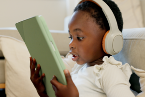 Child with headphones watching a video on tablet
